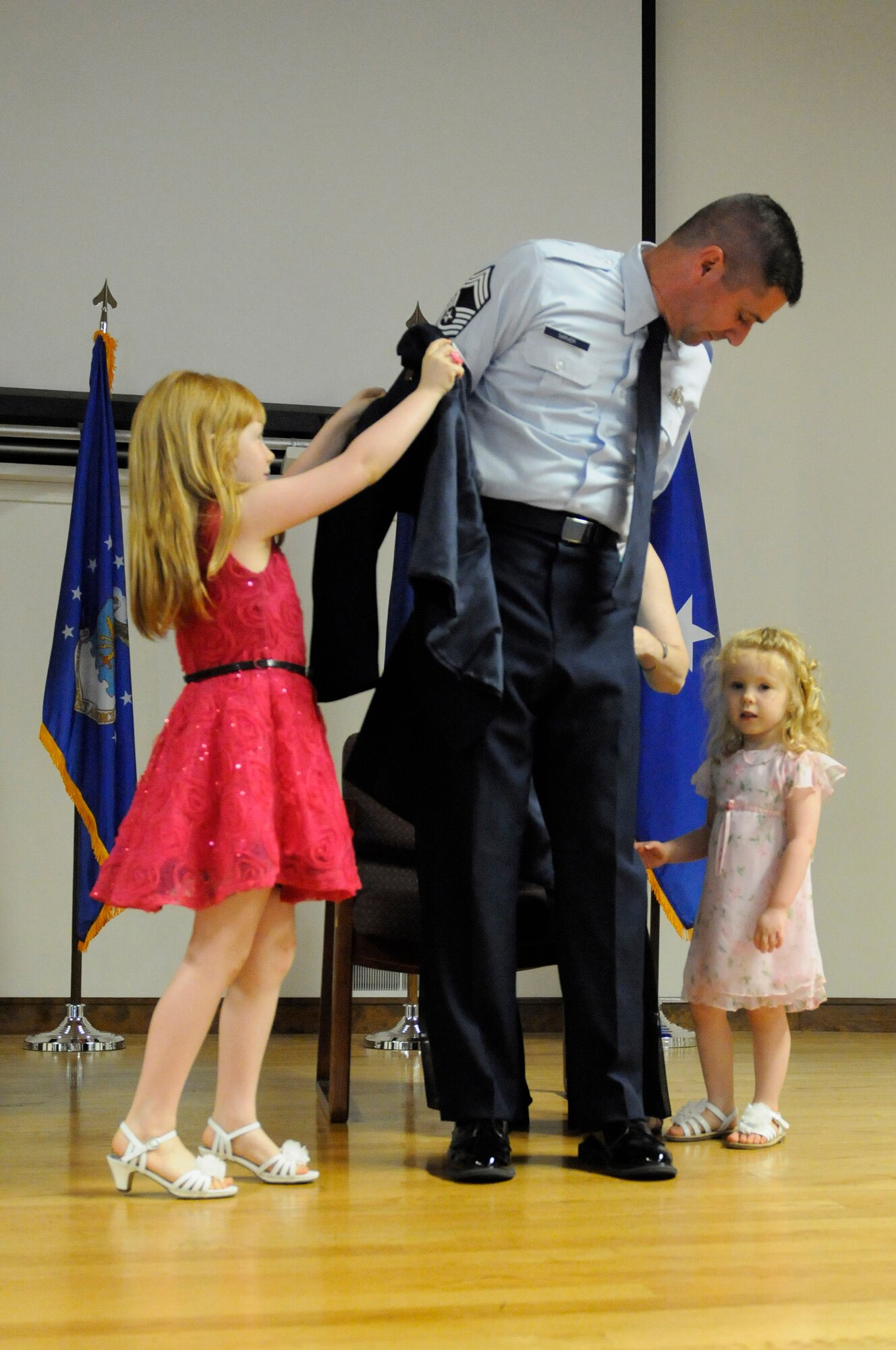 Jeffrey A. Sarver is promoted to the rank of chief master sergeant with the help of his family during a ceremony held at the Kentucky Air National Guard Base, Louisville, Ky., June 7, 2015.  Sarver is logistics planner for Joint Forces Headquarters—Kentucky. (U.S. Air National Guard photo by Staff Sgt. Vicky Spesard)