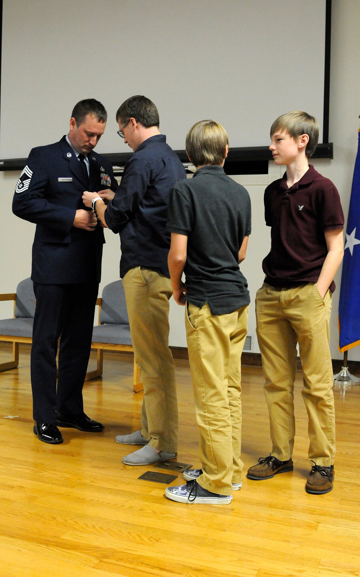 Derek Whitmer is promoted to the rank of chief master sergeant with the help us his sons during a ceremony held in at the Kentucky Air National Guard Base in Louisville, Ky., Oct. 18, 2015.  Whitmer is superintendent of the 123rd Contingency Response Group. (U.S. Air National Guard photo by Tech. Sgt. Vicky Spesard)