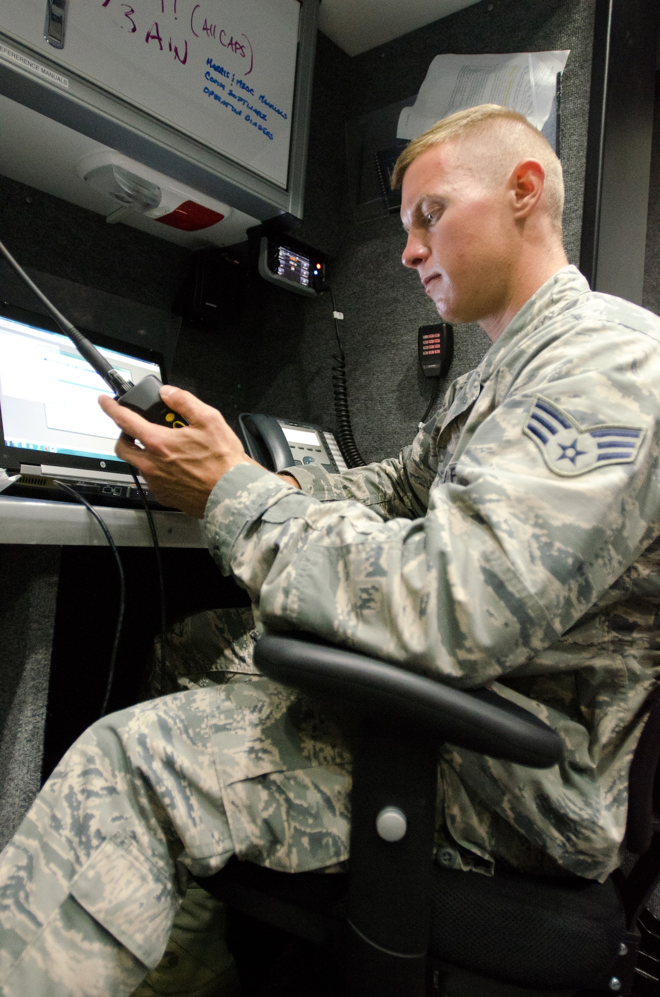 Senior Airman Kaleb Henry, a readiness program specialist for the 123rd Civil Engineer Squadron, programs a handheld radio for communications during a state-wide communication exercise at the Kentucky Air National Guard Base in Louisville, Ky., June 25, 2015. The Kentucky National Guard and multiple federal, state and local agencies participated in the week-long exercise, designed to test the agencies’ ability to communicate with each other during emergencies. (Kentucky Air National Guard photo by Master Sgt. Phil Speck)