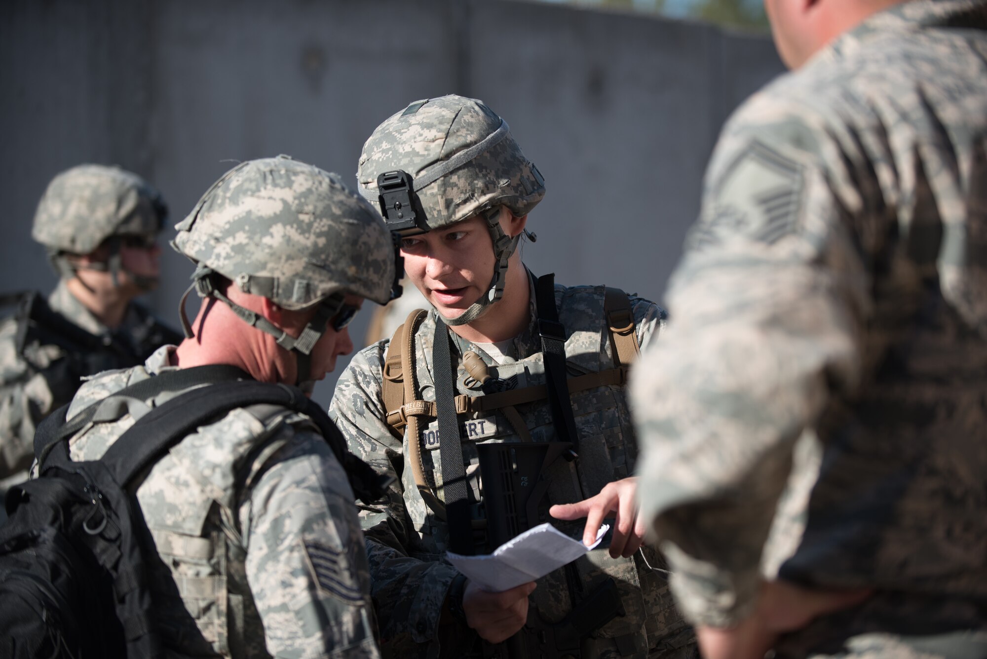 Tech. Sgt. Gary Coy (left) and Tech. Sgt. Julian Borchert, squad leaders from the Kentucky Air National Guard’s 123rd Security Forces Squadron, discuss plans to recover a simulated downed pilot inside a mock Afghan Village at Fort Knox, Ky., Oct. 20, 2015. The Airmen were required to execute a coordinated search while defending their positions and engaging hostile forces. (U.S. Air National Guard photo by Maj. Dale Greer)