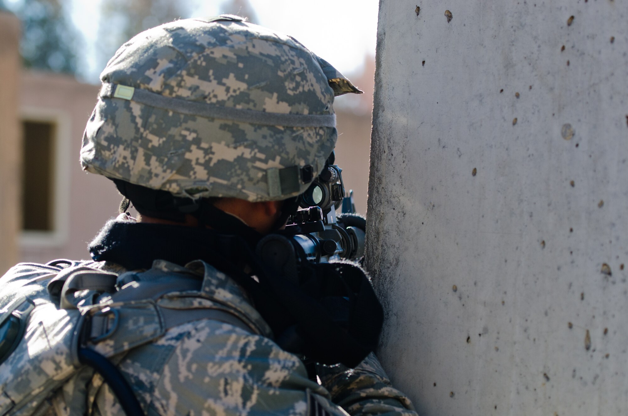 A member of the Kentucky Air National Guard's 123rd Security Forces Squadron lays down suppressive fire during a field training exercise at Ft. Knox, Ky., Oct. 20, 2015. Unit members were being evaluated on their ability to extract a downed pilot from a simulated Afghan village. (Kentucky Air National Guard photo by Master Sgt. Phil Speck)