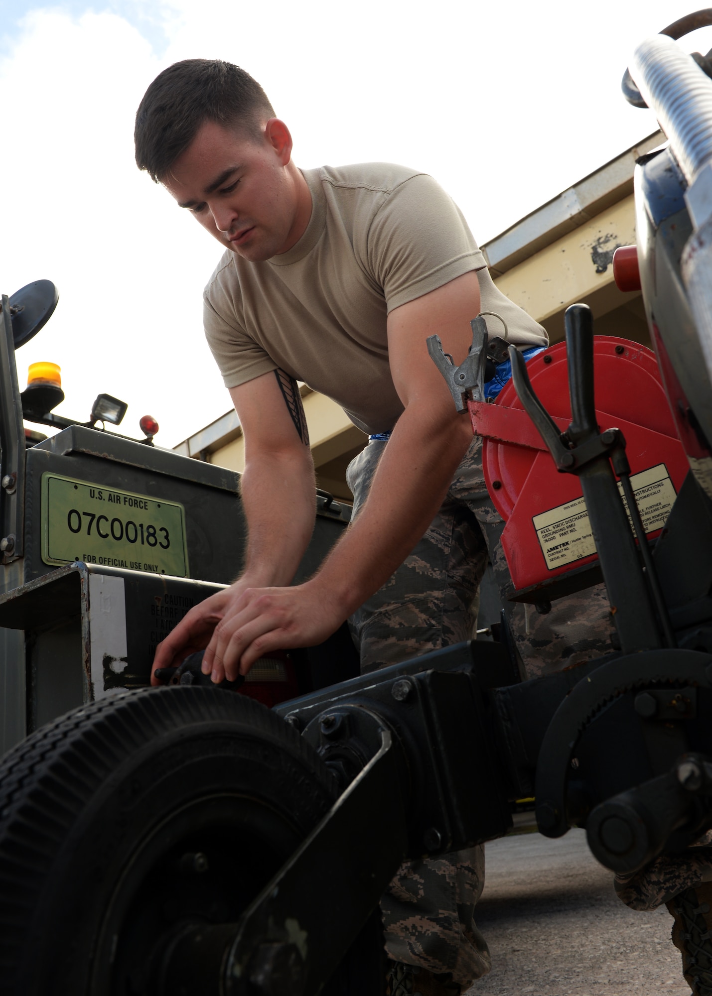 Senior Airman Laenya Maze, 36th Maintenance Squadron, electrical and environmental technician, releases built up pressure from a liquid oxygen cart Dec. 1, 2015 at Andersen Air Force Base, Guam.  On a daily basis, Maze is responsible for inspecting the liquid oxygen carts for discrepancies prior to taking them to the cryogenics shop. (U.S. Air Force photo/Senior Airman Cierra Presentado) 