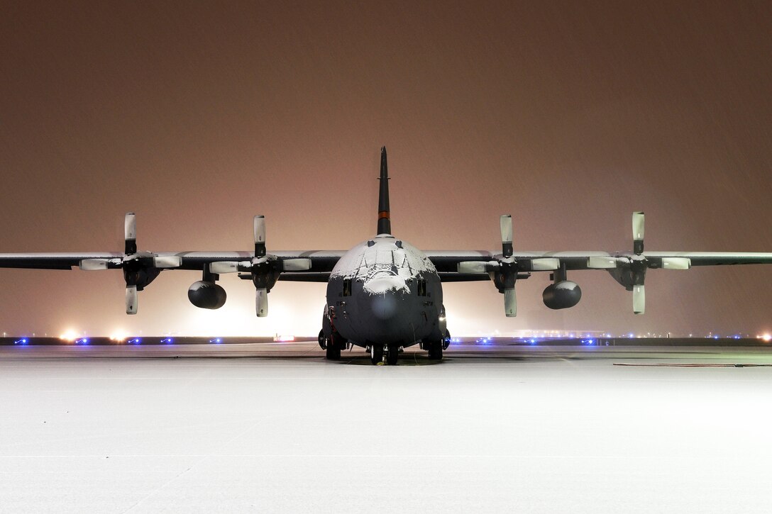 Snow falls on a C-130 Hercules aircraft assigned to the 182nd Airlift Wing, Illinois Air National Guard, in Peoria, Ill., Dec. 30, 2015. U.S. Air National Guard photo by Staff Sgt. Lealan Buehrer