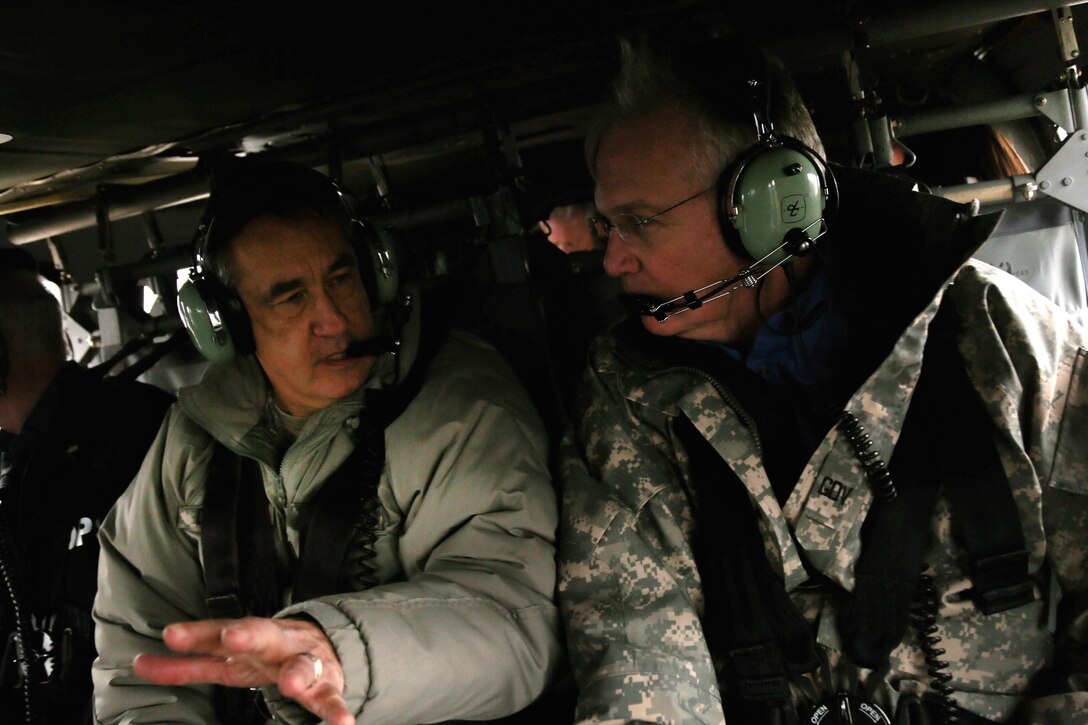 Army Maj. Gen. Stephen L. Danner, left, adjutant general of the Missouri National Guard, talks with Missouri Gov. Jay Nixon aboard a  UH-60 Black Hawk helicopter while observing flooding in Pacific, Mo., Dec. 30, 2015. Missouri National Guard photo