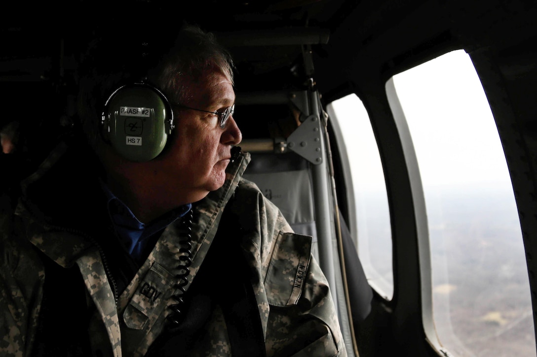 Missouri Gov. Jay Nixon looks out the window of a Missouri National Guard UH-60 Black Hawk while viewing the effects of flooding in Pacific, Mo., Dec. 30, 2015. Missouri National Guard photo