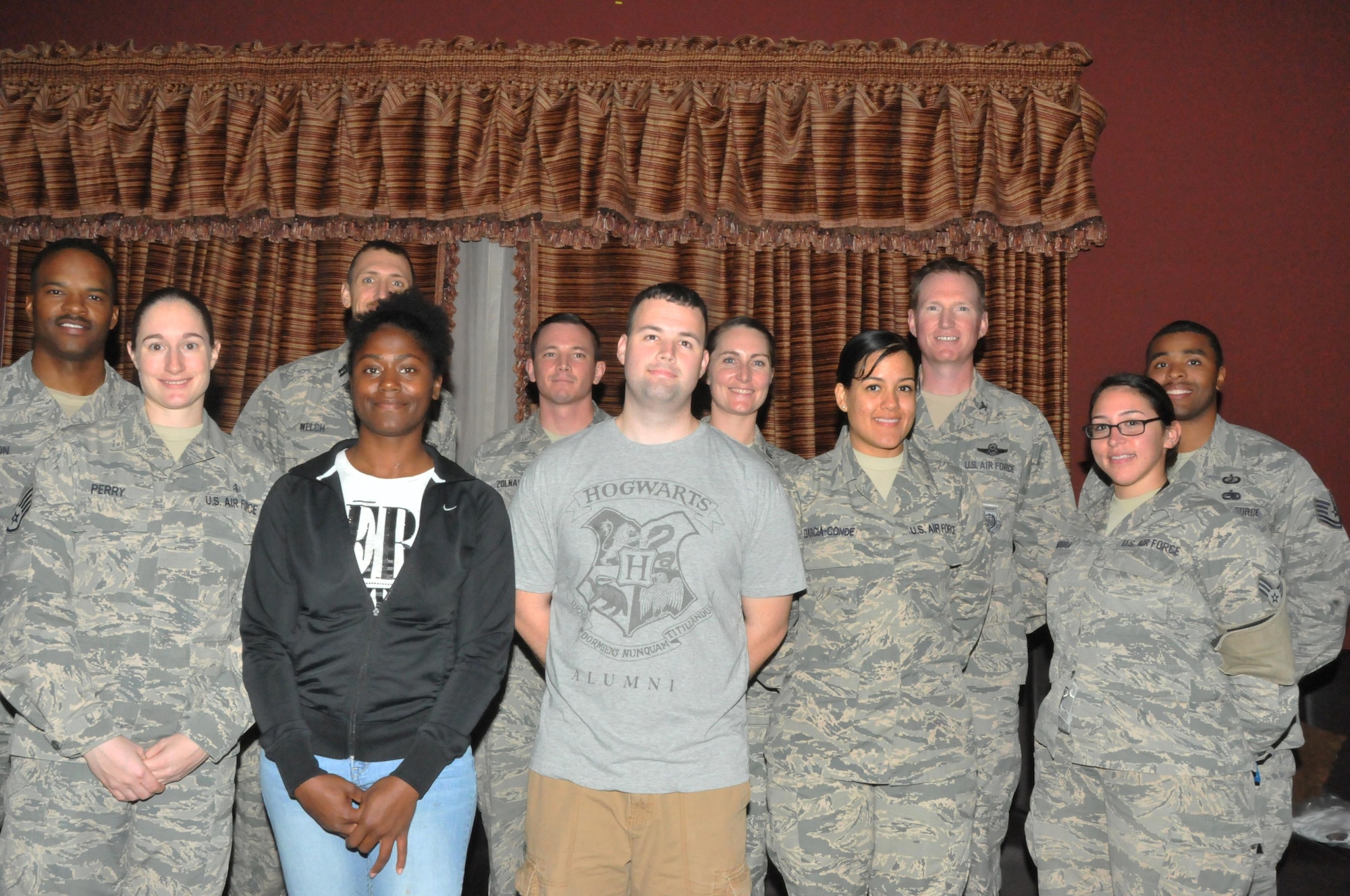 Almost a dozen members of Jar Saleh, a base organization, pose for a photo after receiving the Presidential Volunteer Service Award Dec. 29 at Al Udeid Air Base, Qatar. The PVSA is a volunteer award program that encourages citizens to live a life of service. The program awards the PVSA to people who earn more than 500 hours. (U.S. Air Force photo by Tech. Sgt. Terrica Y. Jones/Released)