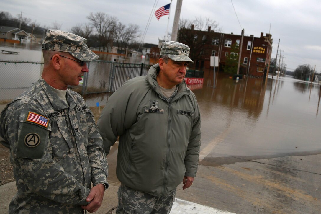 Army Maj. Gen. Stephen L. Danner, right, adjutant general of the Missouri National Guard, talks with Army Col. McKinney while observing the effects of flooding in Pacific, Mo., Dec. 30, 2015. Missouri National Guard photo