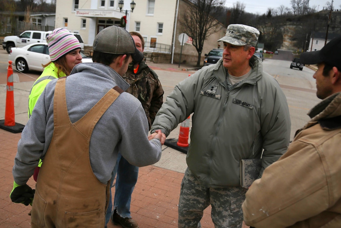 Army Maj. Gen. Stephen L. Danner, right center, adjutant general of the Missouri National Guard, talks with residents and those assisting in relief efforts after observing the devastation from flooding in Pacific, Mo., Dec. 30, 2015. Missouri National Guard photo