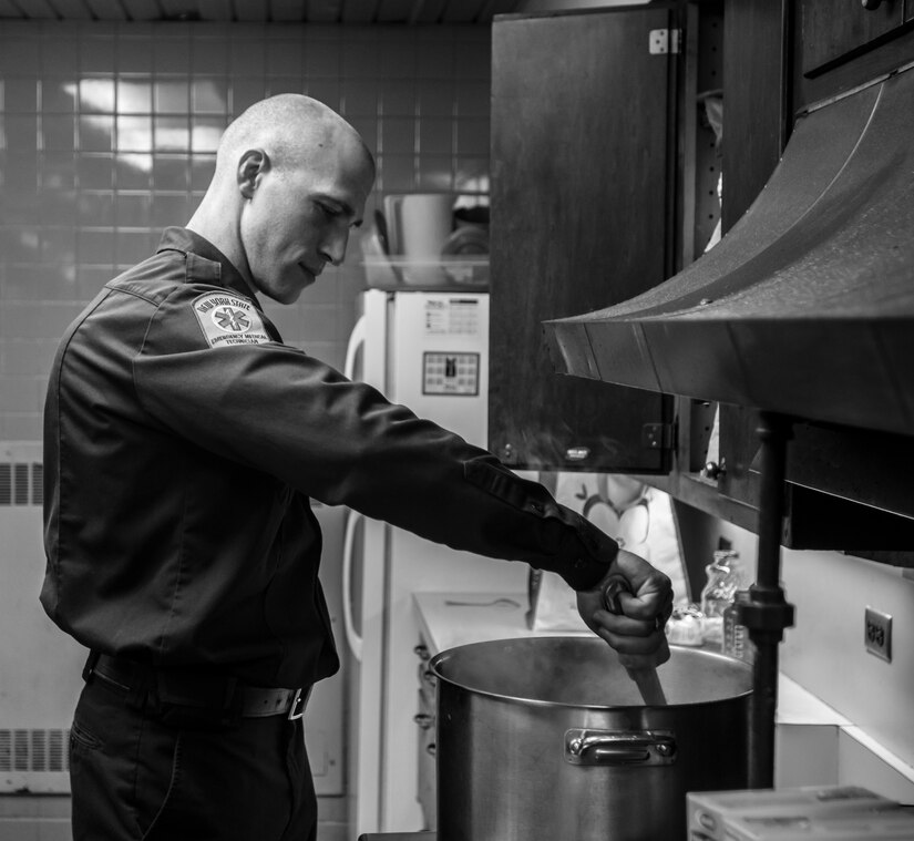 Staff Sgt. Russell Vidler, 98th Training Division (IET) Drill Sergeant of the Year, helps to prepare the meal of the night, spaghetti with zucchini sauce, while at his job as a firefighter with the Ithaca Fire Department in Ithaca, N.Y., Dec. 16, 2015. Vidler has worked as a firefighter with the city of Ithaca for two years now. (U.S. Army photo by Sgt. 1st Class Brian Hamilton)