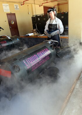 Senior Airman Laenya Maze, a 36th Maintenance Squadron electrical and environmental technician, releases built up pressure from a liquid oxygen cart Dec. 1, 2015, at Andersen Air Force Base, Guam. Before a cart is transported to a jet, all built up pressure is released and the cart must pass inspection. (U.S. Air Force photo/Senior Airman Cierra Presentado)