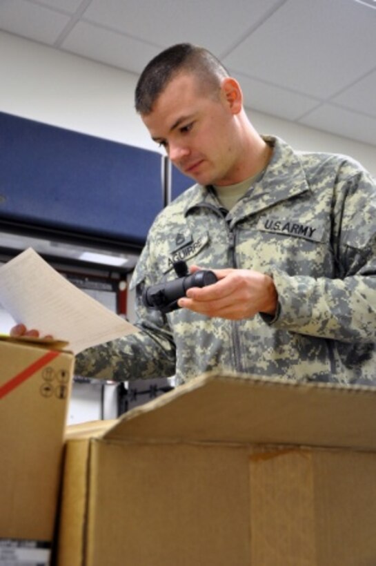 Army Sgt. 1st Class Daniel Aguirre, 33, a Joint Forces Headquarters, Iowa National Guard supply sergeant from Altoona, Iowa, checks incoming equipment against the inventory checklist, Oct. 30, 2015. Iowa National Guard photo by Army Master Sgt. Duff E. McFadden