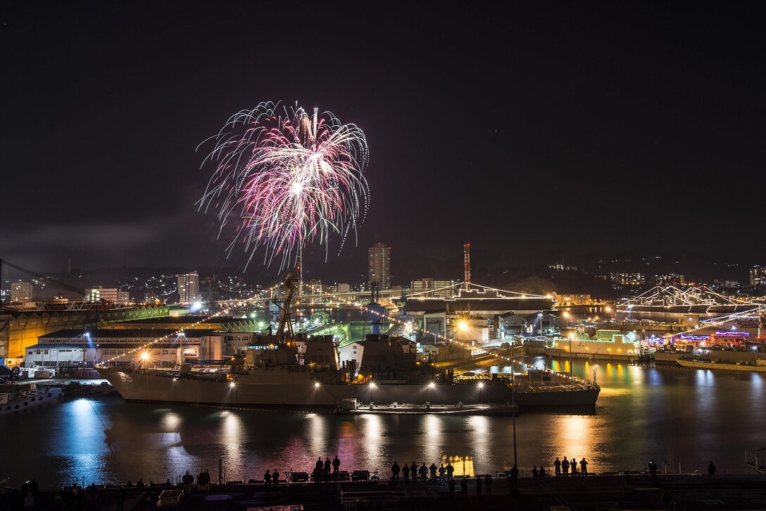 U.S. sailors watch fireworks to celebrate the new year from the flight deck of the USS Ronald Reagan in Commander Fleet Activities Yokosuka, Japan, Jan. 1, 2016. The aircraft carrier and its embarked air wing, Carrier Air Wing 5, provide a combat-ready force to protect and defend the maritime interests of the U.S. and its allies and partners in the Indo-Asia-Pacific region. U.S. Navy photo by Petty Officer 2nd Class Paolo Bayas