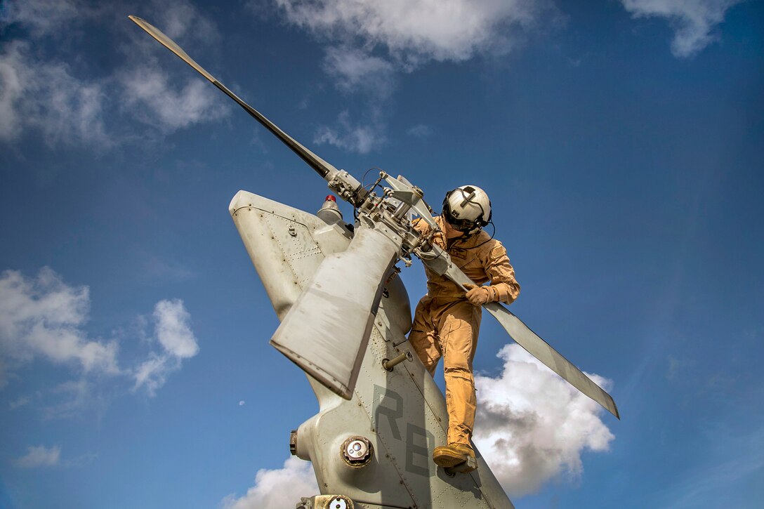 Navy Petty Officer 3rd Class Curt Hanson performs a preflight inspection on an MH-60S Seahawk helicopter before an exercise on Andersen Air Force Base, Guam, Dec. 29, 2015. U.S. Navy photo by Chief Petty Officer Joan E. Jennings
