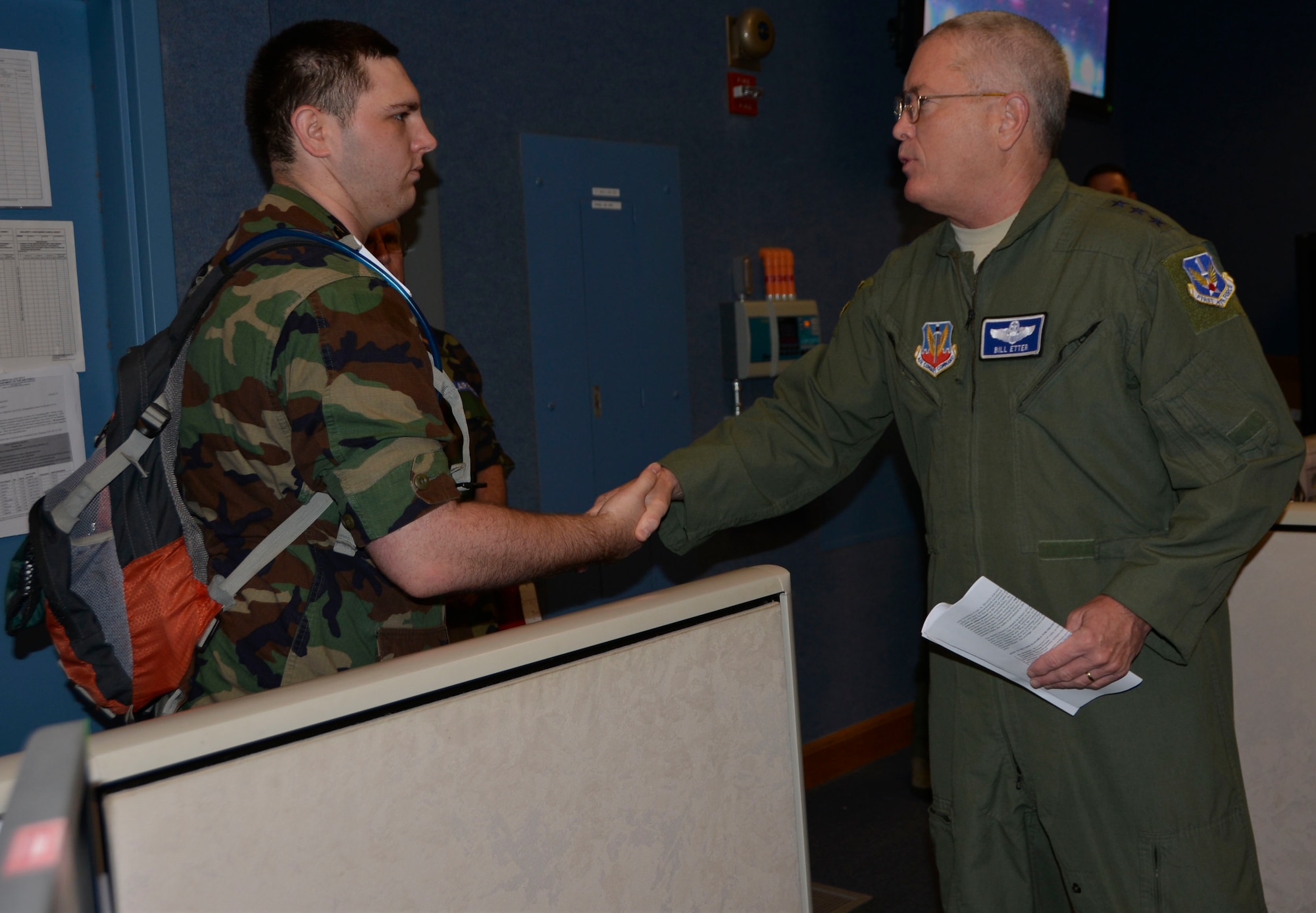TYNDALL AIR FORCE BASE, Fla. - Lt. Gen. William Etter, Continental  U.S. North American Aerospace Defense Command Region – 1st Air Force (Air Forces Northern) commander, presents his commander’s coin for recognition of superior performance  to Civil Air Patrol Cadet/2d Lieutenant  Steven Conway of Lake Composite Squadron Fl-021 during a CAP cadet tour of the 601st Air Operations Center Wednesday. Conway is a CAP Silver Medal of Honor recipient who distinguished himself when, during a visit to a local store, he rushed to a store worker under attack by a man wielding a knife. He pulled the man off the worker and is credited by police for probably saving the woman’s life. The attacker fled but was subsequently captured by authorities shortly thereafter. Conway and the other cadets were visiting the 601st AOC as part of their annual week-long winter encampment event designed provide an in-depth orientation to the Civil Air Patrol and the United States Air Force. (Air Force Photo Released/Mary McHale)


