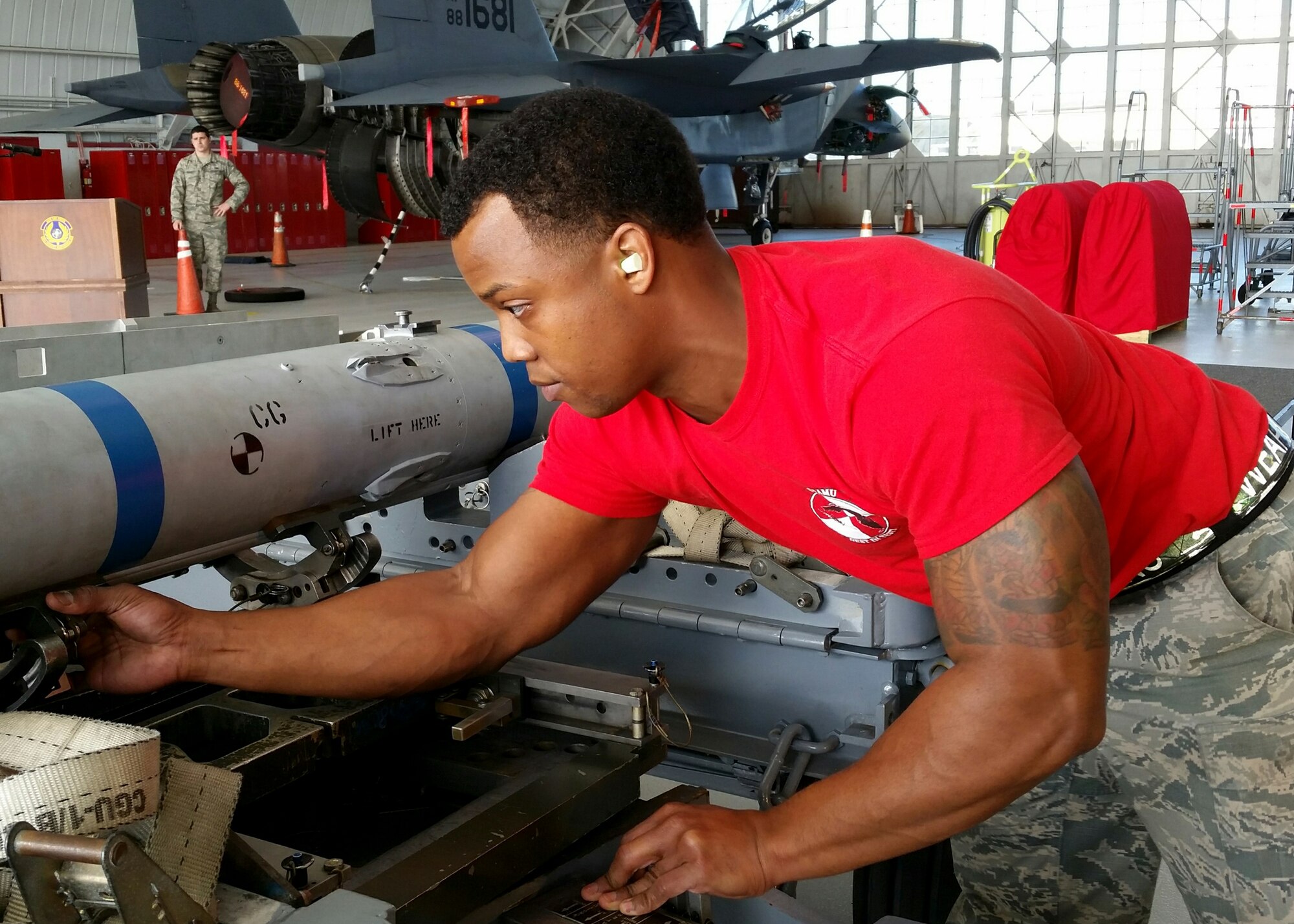 Staff Sgt. Tyson Dunston, of the 96th Aircraft Maintenance Squadron Red, prepares to lift an AIM-120 missile from a munition trailer to mount onto the F-15 Strike Eagle, during the fourth quarter weapons loadcrew competition Dec. 18 at Eglin Air Force Base, Fla.  Dunston, Airman 1st Class Aaron Shirk and Airman 1st Class Aaron Jennings represented the Red AMU. The Red team lost to the Blue team in the competition. (U.S. Air Force photo/Kevin Gaddie)  