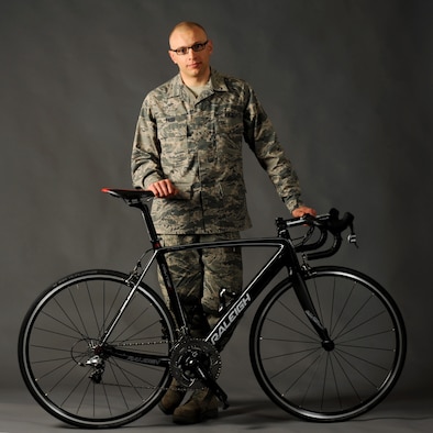 Oregon Air National Guard Tech. Sgt. Dwayne Farr, assigned to the 142nd Fighter Wing Aircraft Maintenance Squadron, poses with one of his bicycles during a photo shoot at the air base Public Affairs office, Portland Air National Guard Base, Ore., April 7, 2013. Farr has been training and racing as an endurance cyclist during the past four years and was part of the Military World Games in Mungyeoung, Korea, October 6, 2015. (U.S. Air National Guard photo by Tech. Sgt. John Hughel, 142nd Fighter Wing Public Affairs/Released)