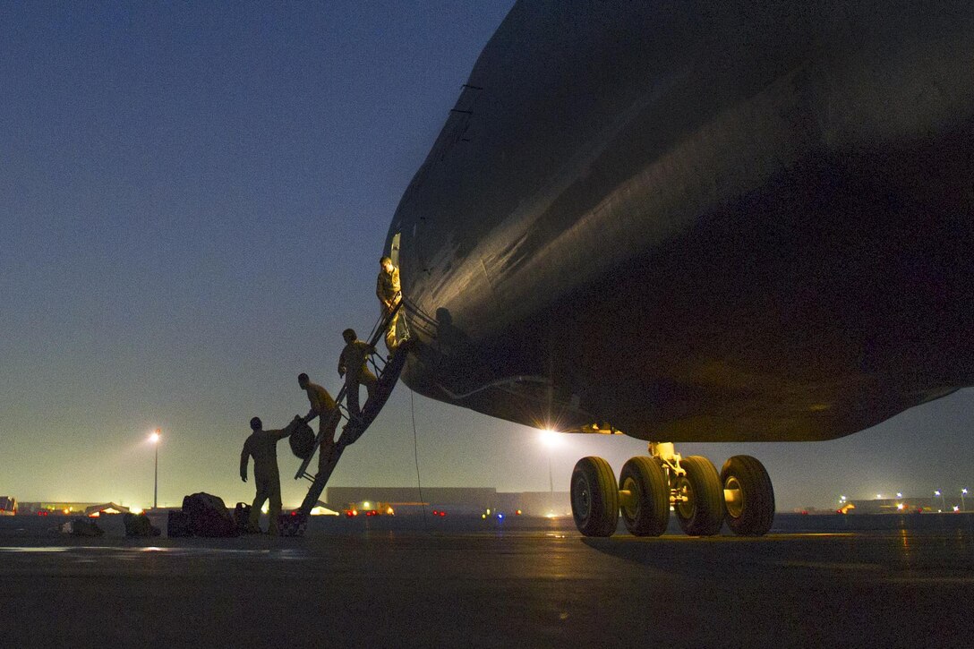 U.S. flight crewmen load their bags on a C-5 Galaxy as it sits on the ramp on Bagram Airfield, Afghanistan, Dec. 28, 2015. As the largest U.S. military aircraft, the C-5 Gallaxy can carry more than 270,000 pounds of cargo. U.S. Air Force photo by Tech. Sgt. Robert Cloys