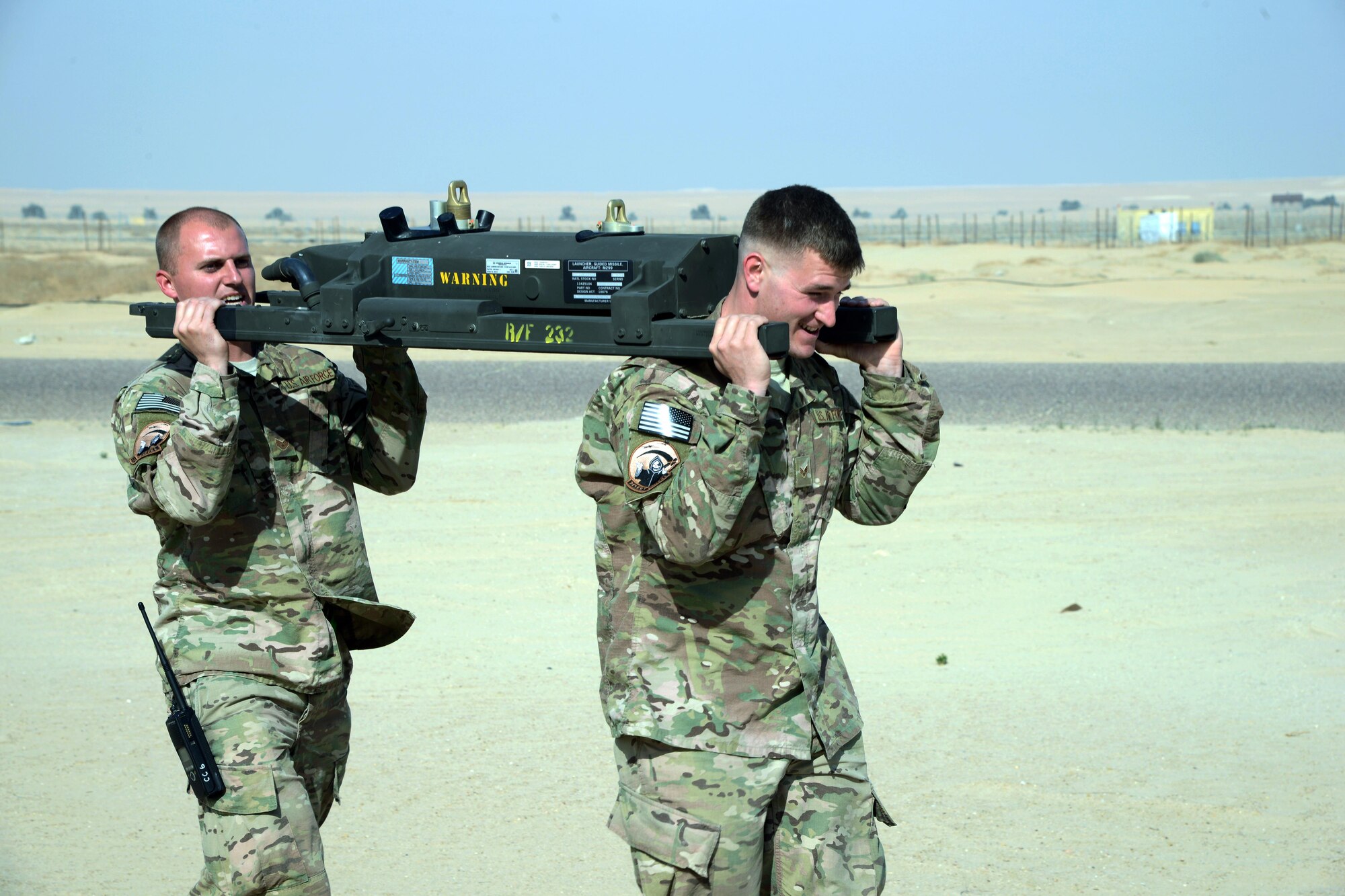 SOUTHWEST ASIA - Staff Sgt. James Mitchell (left) and Senior Airman Wesley Boaz, 386th Expeditionary Aircraft Maintenance Squadron, transport an M299 launcher rail to an MQ-9 Reaper here Jan. 28, 2015. Mitchell and Boaz are deployed from the 27th Special Operations Maintenance Squadron at Cannon Air Force Base, New Mexico. (U.S. Air Force photo by Tech. Sgt. Jared Marquis/released)