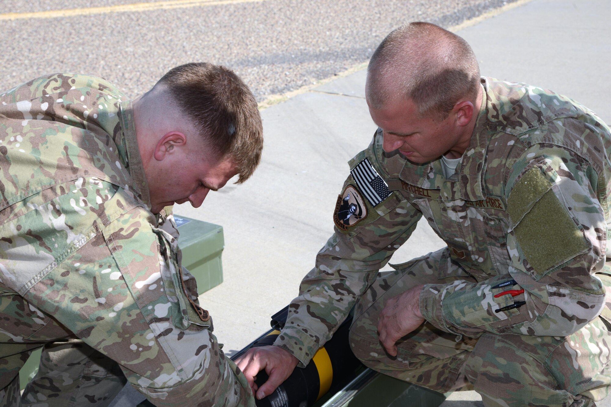 SOUTHWEST ASIA - Staff Sgt. James Mitchell (right) and Senior Airman Wesley Boaz, 386th Expeditionary Aircraft Maintenance Squadron, secure an AGM-114 Hellfire Missile here Jan. 28, 2015. Mitchell and Boaz are both deployed from the 27th Special Operations Maintenance Squadron at Cannon Air Force Base, New Mexico. (U.S. Air Force photo by Tech. Sgt. Jared Marquis/released)