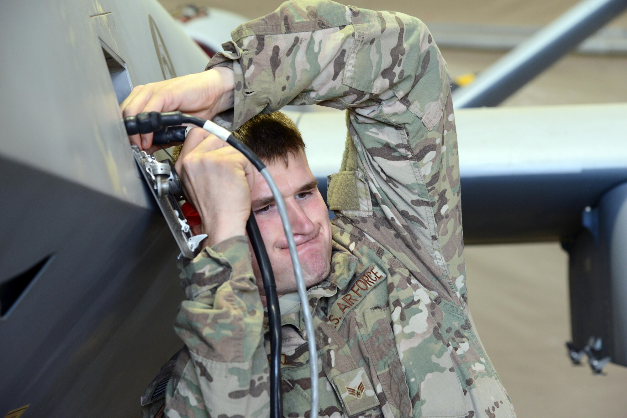 SOUTHWEST ASIA - Senior Airman Wesley Boaz, 386th Expeditionary Aircraft Maintenance Squadron, connects a cable for an operational checkout on an M299 launcher rail here Jan. 28, 2015.  Boaz is deployed from the 27th Special Operations Maintenance Squadron at Cannon Air Force Base, New Mexico. (U.S. Air Force photo by Tech. Sgt. Jared Marquis/released)