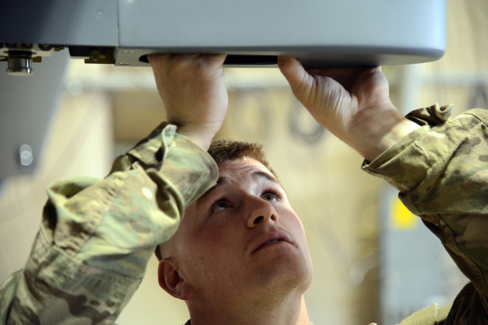 SOUTHWEST ASIA - Senior Airman Wesley Boaz, 386th Expeditionary Aircraft Maintenance Squadron, removes an M299 launcher rail from an MQ-9 Reaper here Jan. 28, 2015. Boaz is deployed from the 27th Special Operations Maintenance Squadron at Cannon Air Force Base, New Mexico. (U.S. Air Force photo by Tech. Sgt. Jared Marquis/released)