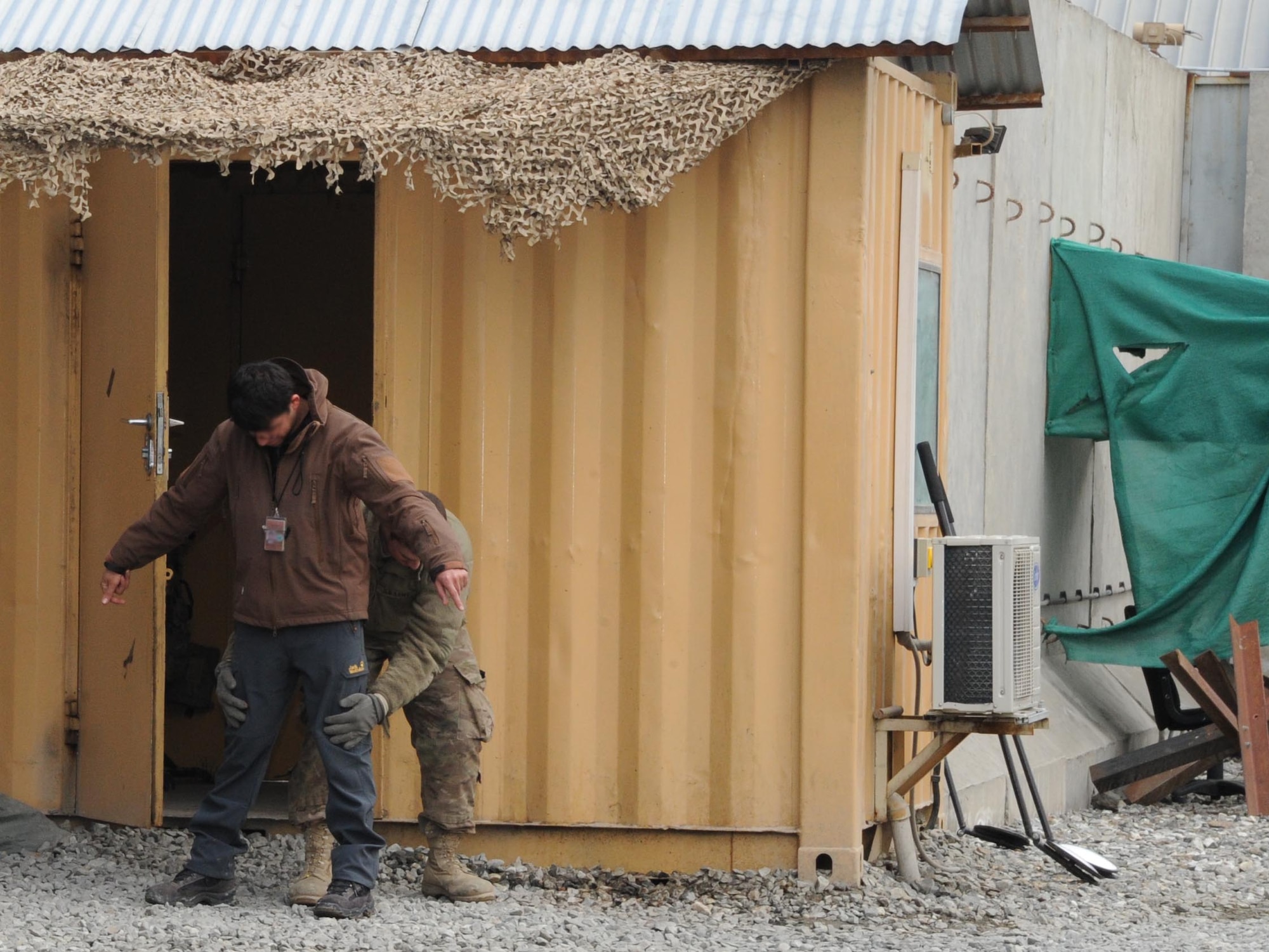Spc. David Leggitt, 950th Engineer Company, TAAC-Air base security searches a local national before he enters the TAAC-Air base.  Leggitt is one of more than 50 members of the Wisconsin Army National Guard who provide security for Train, Advise, Assist Command - Air. (Air Force photo by Senior Master Sgt. J. LaVoie/Released)