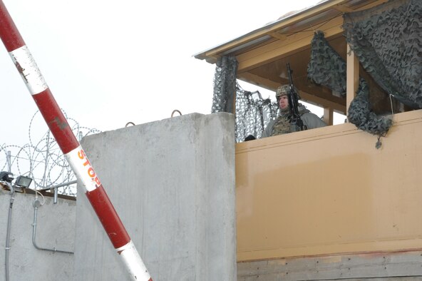 Spc. Jacob Chappa, 950th Engineer Company, TAAC-Air base security provides over watch to the base's entry.  Jacon is one of more than 50 members of the Wisconsin Army National Guard who provide security for Train, Advise, Assist Command - Air. (Air Force photo by Senior Master Sgt. J. LaVoie/Released)