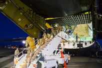 California Air National Guard members from the 129th Rescue Wing, Moffett Federal Airfield, Calif., prepare to board a C-17 Globemaster aircraft for their overseas deployment. 