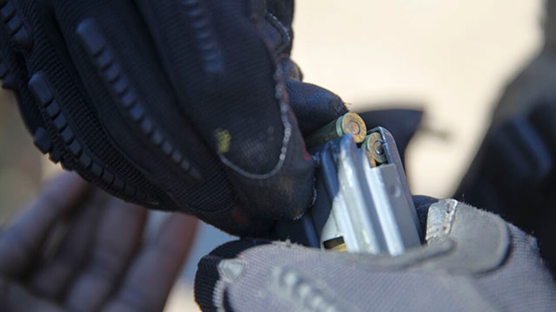 A Marine part of the security forces with Headquarters Battalion, 2nd Marine Division, loads 5.56 mm rounds into a magazine before conducting a patrol of the compound during a command post exercise at Landing Zone Bluebird, Jan. 28, 2015, aboard, Marine Corps Base Camp Lejeune, N.C.  During the patrols, Marines would toured the compound in 4-man fire teams and perform security details when needed.  Other tasks include guard duty, quick ready force preparation and entry control point duty.  (U.S. Marine Corps photo taken by Lance Cpl. Alexander Mitchell/released)