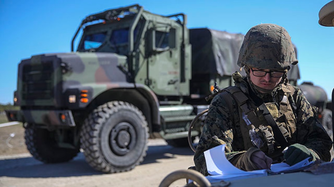 Lance Cpl. Devyn Hodges, an entry control point guard and motor transport operator with Headquarters Battalion, Truck Company, 2nd Marine Division, writes down information in a logbook as a 7-ton truck carrying Marines travels though the command post exercise ECP at Landing Zone Bluebird on Marine Corps Base Camp Lejeune, N.C., Jan. 28, 2015.  ECP guard’s duty is to control movement going in and out of the compound and maintain awareness at all times to keep the compound safe.  (U.S. Marine Corps photo taken by Lance Cpl. Alexander Mitchell/released)