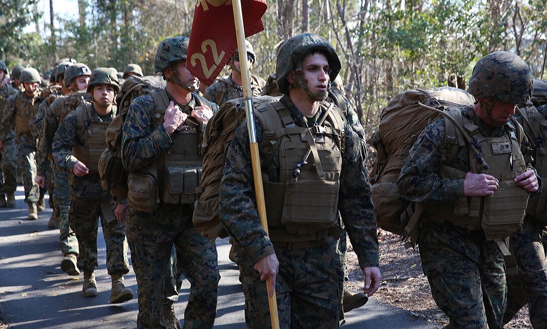 U.S. Marine Corps Sgt. Edward Peifer, 22nd Marine Expeditionary Unit (MEU) supply administrative chief and native of Lake Placid, Fla., marches with the MEU guidon in a five-mile unit hike at Marine Corps Base Camp Lejeune, N.C., Jan. 30, 2015. The unit conducted the hike to maintain unit readiness and build morale. (U.S. Marine Corps photo by Cpl. Caleb McDonald/Released)