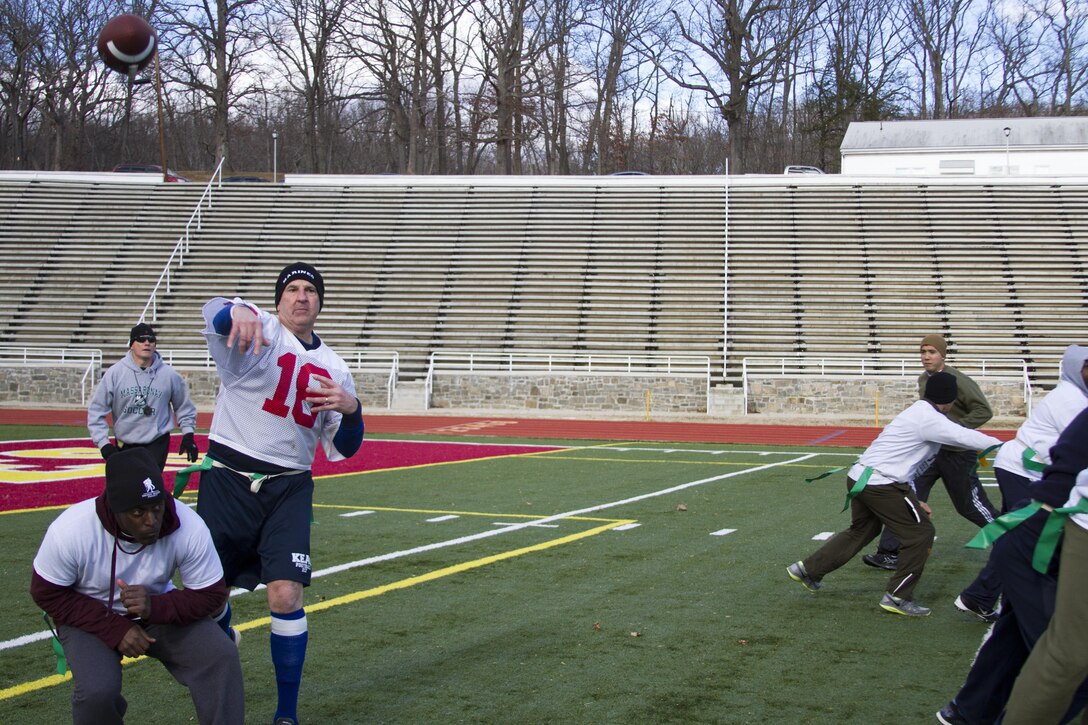 MARINE CORPS BASE QUANTICO, Va. - Colonel Robert G. Golden III, chief of staff, Marine Corps Recruiting Command, passes to Sgt. Joe Randall Jr. (not pictured) for a first down during MCRC Bowl II here, Jan. 30. Golden was team captain and dominated the field as quarterback against the opposing team, captained by Maj. Gen. Mark A. Brilakis, commanding general, MCRC. Golden led his team to victory in overtime, with a final score of 22-21 after a two point conversion. The chief of staff's team has been victorious in the first two MCRC Bowls.