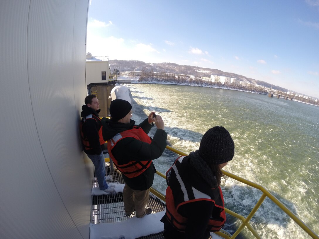 University of Pittsburgh graduate students participating in an urban infrastructure seminar learn about navigation on the Ohio River as they take in the view from atop the Emsworth Locks and Dam service bridge.