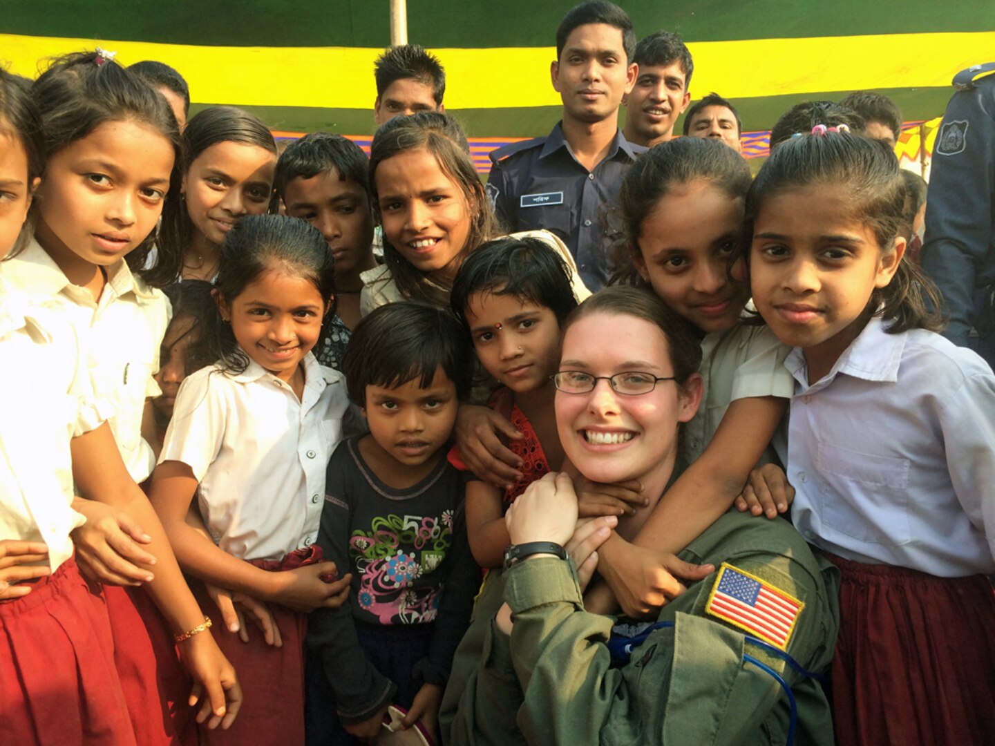 SYHLET, Bangladesh (Jan. 28, 2015) - U.S. Air Force Senior Airman Taylor Hubstenberger takes a photo with students at Goainghat Primary School during Exercise COPE SOUTH,. COPE SOUTH helps cultivate common bonds, foster goodwill, and improve readiness and compatibility between members of the Bangladesh and U.S. Air Forces. 