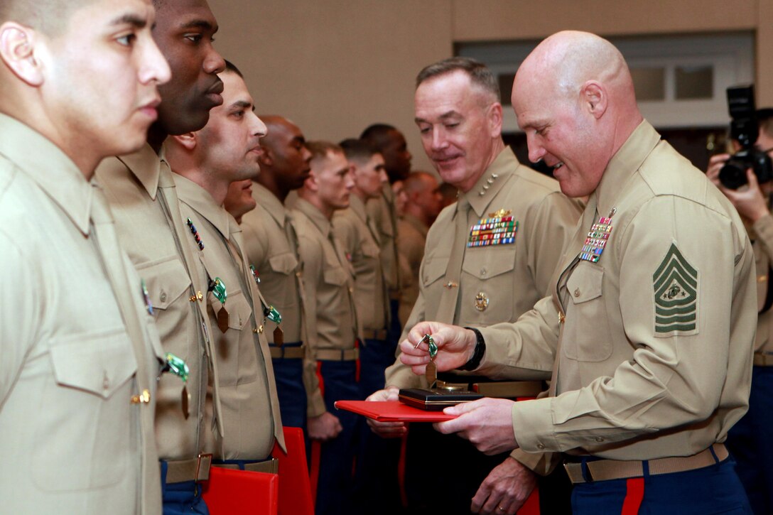 Gen. Joseph F. Dunford, the 36th Commandant of the Marine Corps, and Sgt. Maj. Micheal P. Barrett, the 17th Sergeant Major of the Marine Corps, present awards during the 2014 Combined Awards Ceremony at the Clubs of Quantico in Quantico, Va., Jan. 29, 2014. (U.S. Marine Corps photo by Sgt. Marionne T. Mangrum)