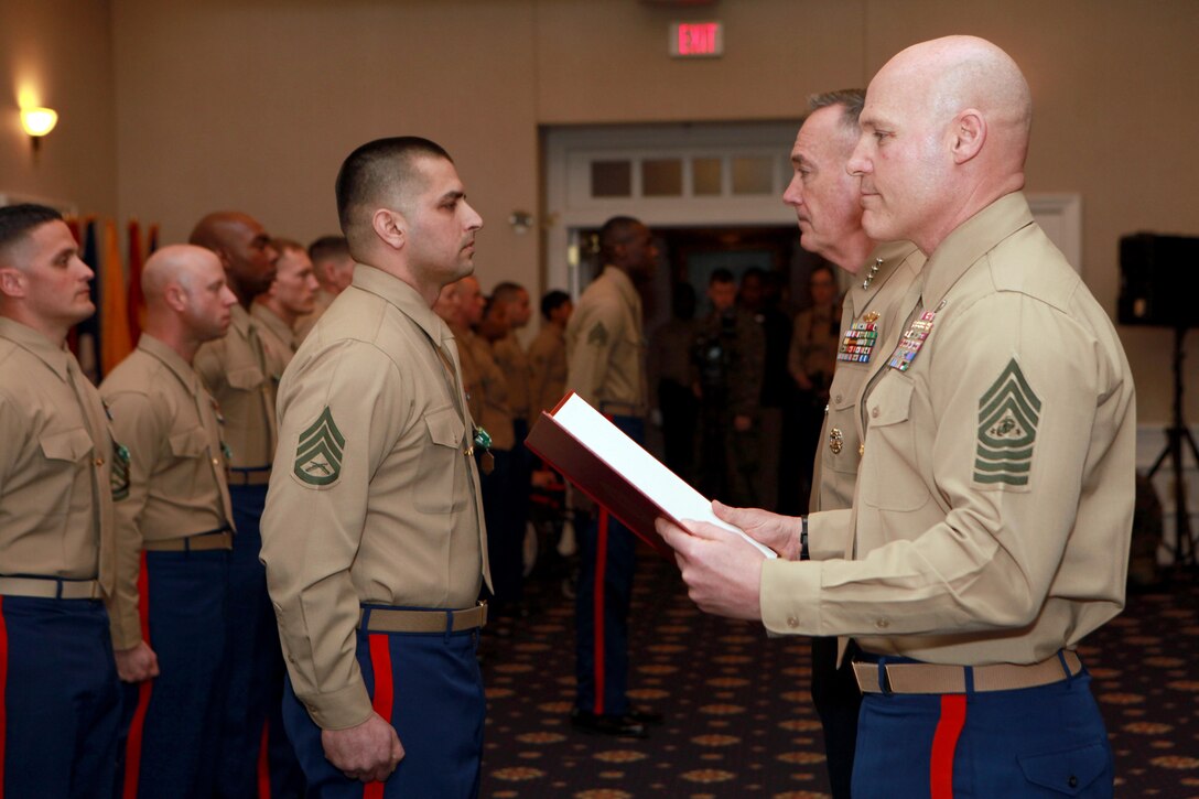 Gen. Joseph F. Dunford, the 36th Commandant of the Marine Corps, and Sgt. Maj. Micheal P. Barrett, the 17th Sergeant Major of the Marine Corps, meritoriously promote Staff Sgt. Orlando Torres to the rank of Gunnery Sgt. during the 2014 Combined Awards Ceremony at the Clubs of Quantico in Quantico, Va., Jan. 29, 2014. (U.S. Marine Corps photo by Sgt. Marionne T. Mangrum)