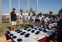Brig. Gen. Tracy King gives closing remarks after a baseball clinic Jan. 24 on Camp Kinser. This was the first baseball clinic held on Camp Kinser. The clinic consisted of Japanese major league baseball player Keiichi Hirano instructing the players on fundamental skills and techniques of baseball followed by a friendly game. “Watching Hirnao interact with the kids and seeing how the kids respond to a guy who is truly passionate about the game was my favorite part,” said King. “They were wide-eyed, paying attention and not fidgeting around. That was enjoyable to see.” The clinic consisted of Hirano instructing the players on fundamental skills and techniques of baseball followed by a friendly game. The day ended with prizes, lunch and a cake for all who participated. King is the commanding general of 3rd Marine Logistics group, III Marine Expeditionary Force. (U.S. Marine Corps photo by Cpl. Rebecca Elmy/Released)