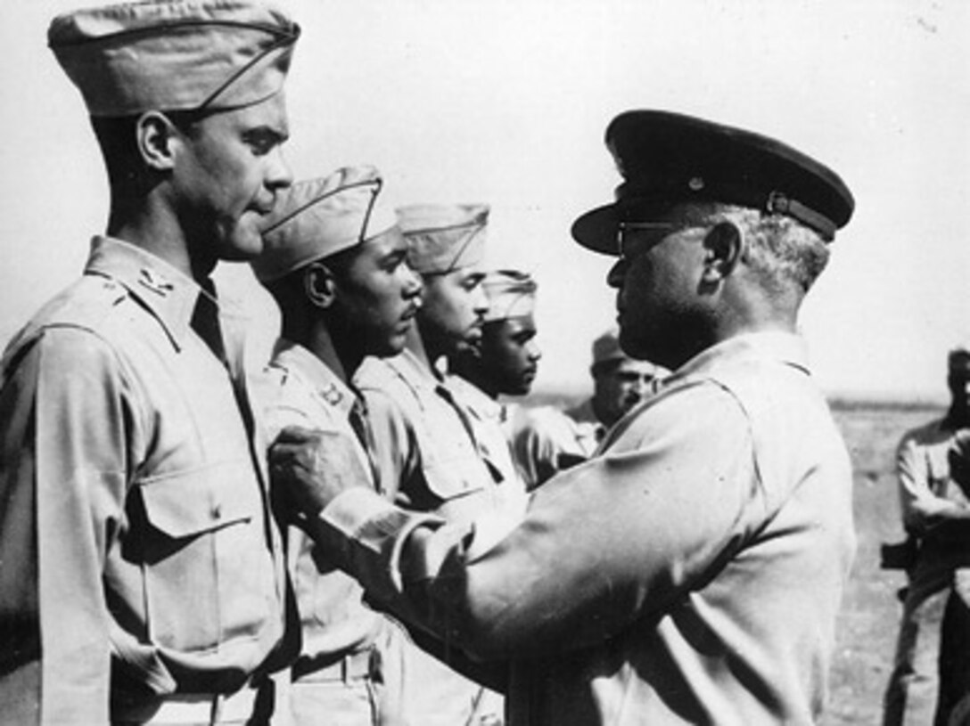 Tuskegee Airman Col. Benjamin O. Davis Jr., left, receives the Distinguished Flying Cross from his father, Brig. Gen. Benjamin O. Davis Sr. at Ramitelli Airfield in Italy in September 1944. Benjamin Davis Sr. was the first black General in the U.S. Army and his son became the first black General in the U.S. Air Force.
(Courtesy of the Air Force Historical Research Agency)