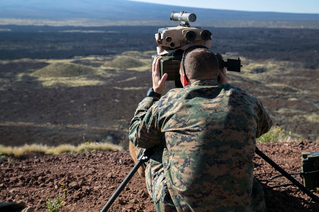 Staff Sgt. Peter Burchfield, from Boston, Massachusetts, sights in on a target with a AN/PED-1 Lightweight Laser Designator Rangefinder Jan. 16 during Exercise Lava Viper 15.1-2 at Pohakuloa Training Area, Hawaii, Hawaii. After sighting in, the device emits a laser which marks simulated hostile threats for air assets. The laser provides Marine pilots with the exact location of targets and suspected threats without putting the operator in harm’s way. Burchfield is a joint terminal attack controller with 5th Air Naval Gunfire Liaison Company, III Marine Expeditionary Force Headquarters Group, III MEF. 