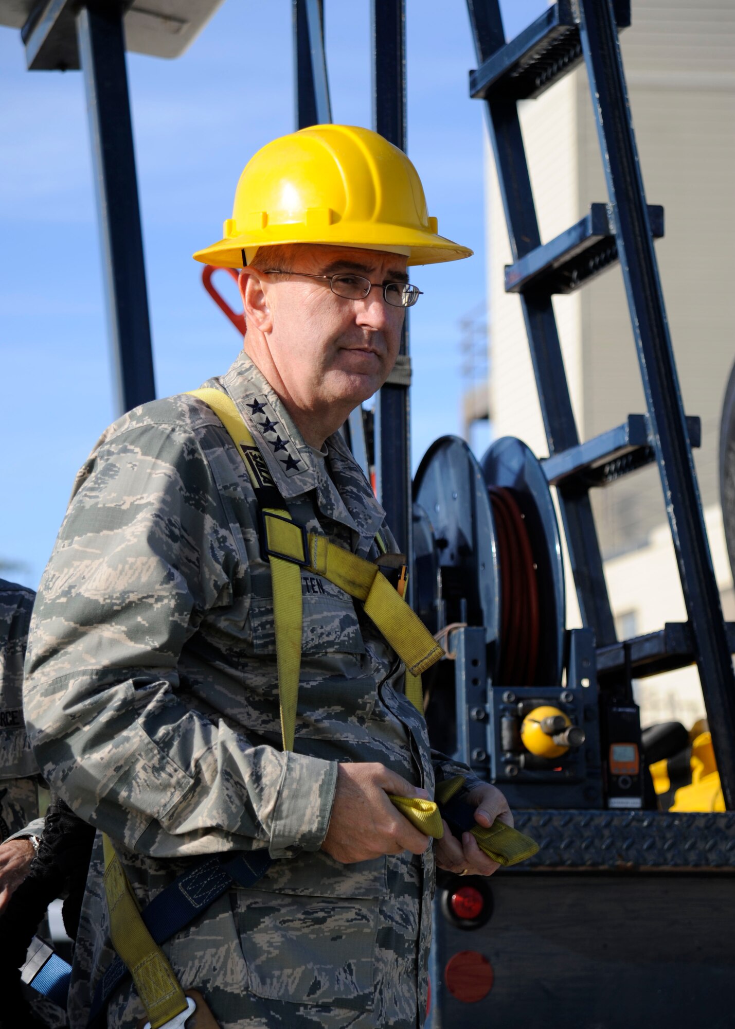 Gen. John Hyten, commander, Air Force Space Command, secures his safety harness during a 30th Mission Support Group demonstration, Jan. 29, 2015, Vandenberg Air Force Base, Calif. As part of the demonstration, Hyten received a ride in an elevated work platform, also known as a cherry picker. (U.S. Air Force photo by Airman 1st Class Ian Dudley/Released)