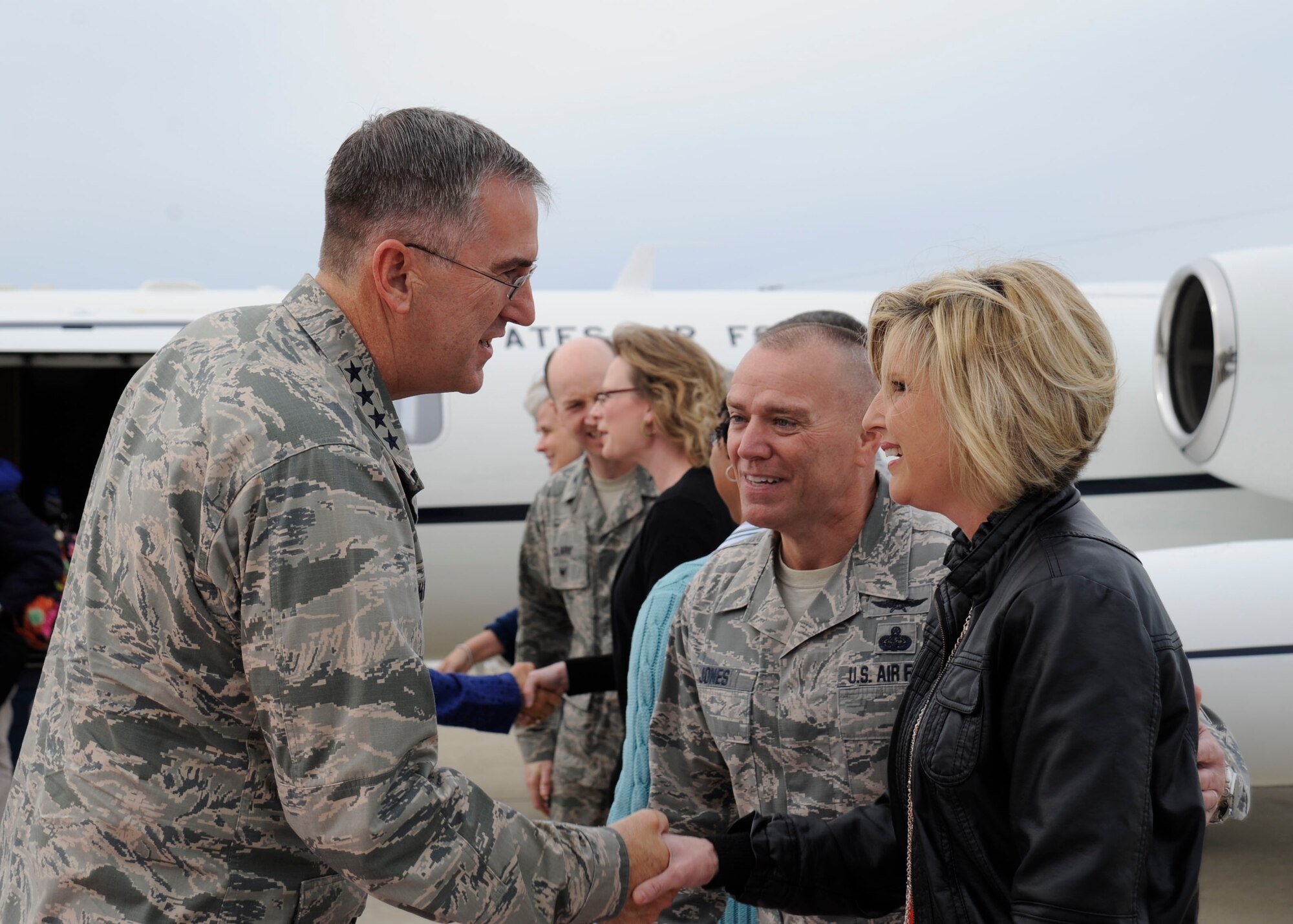 Gen. John Hyten, commander, Air Force Space Command, is greeted by Chief Master Sgt. William “DJ” Jones, 30th Space Wing command chief, and his wife Jenny, Jan. 28, 2015, Vandenberg Air Force Base, Calif. As part of Hyten’s first visit to Vandenberg since taking command, he received an aerial tour on an HH-60 Pave Hawk helicopter and tours of the Western Range Operations Control Center (WROCC) as well as various units on base. He also held an All-Call to address his views on leadership and future space capabilities. (U.S. Air Force photo by Airman 1st Class Ian Dudley/Released)