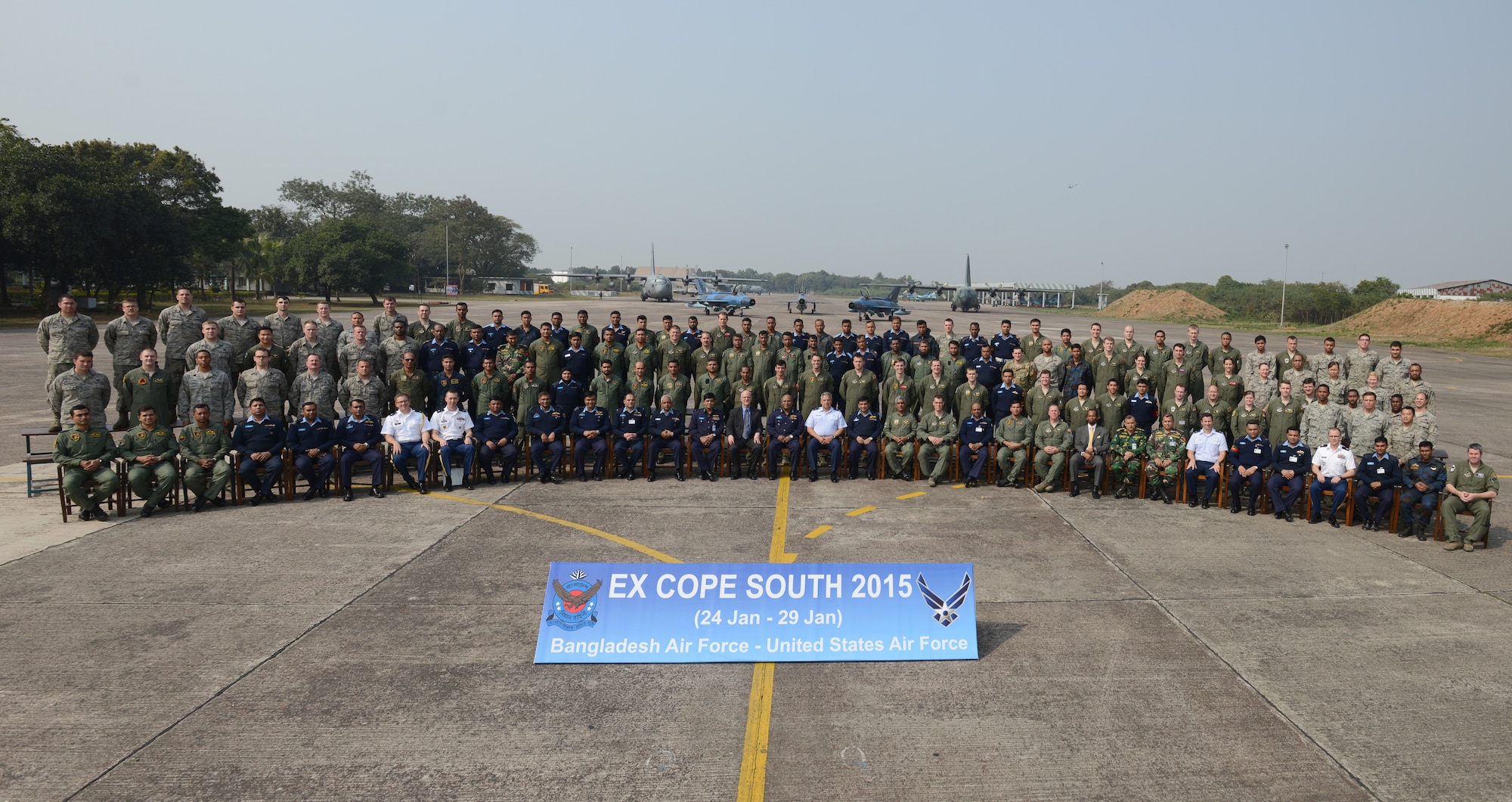 U.S. Air Force and Bangladesh Air Force personnel gather for a group photo at the close of Exercise COPE SOUTH at BAF Base Bangabandhu, Bangladesh, Jan. 29, 2015. COPE SOUTH helps cultivate common bonds, foster goodwill, and improve readiness and compatibility between members of the Bangladesh and U.S. Air Forces. COPE SOUTH is a Pacific Air Forces-sponsored, bilateral tactical airlift exercise conducted in Bangladesh, with a focus on cooperative flight operations, day and night low-level navigation, tactical airdrop, and air-land missions as well as subject-matter expert exchanges in the fields of operations, maintenance and rigging disciplines. (U.S. Air Force photo by 1st Lt. Jake Bailey/Released)