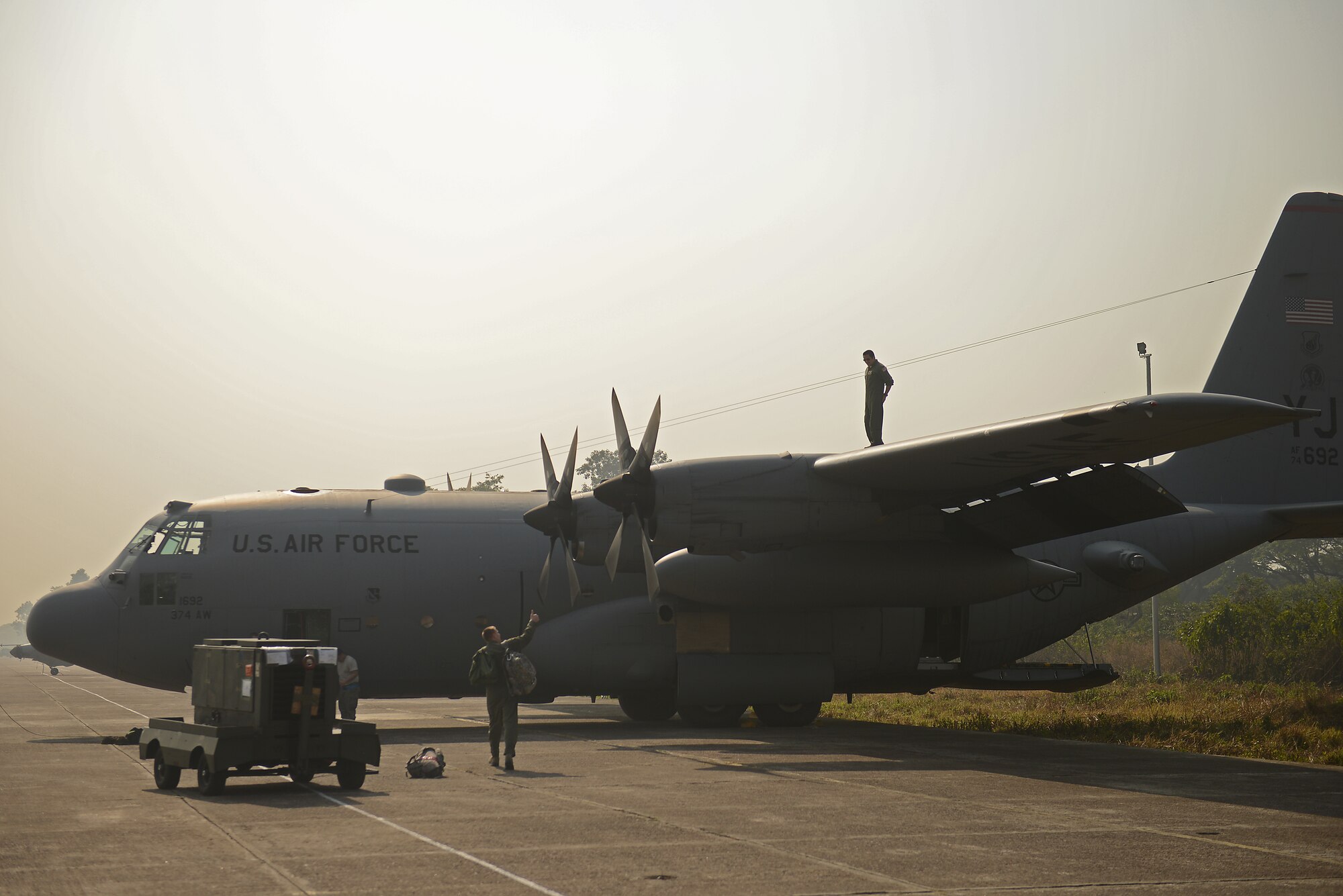 A C-130H aircraft crew from the 374th Airlift Wing, Yokota Air Base, Japan, prepare for a mission during Exercise COPE SOUTH at BAF Base Bangabandhu,  Bangladesh, Jan. 28, 2015. COPE SOUTH is a Pacific Air Forces-sponsored, bilateral tactical airlift exercise conducted in Bangladesh, with a focus on cooperative flight operations, day and night low-level navigation, tactical airdrop, and air-land missions as well as subject-matter expert exchanges in the fields of operations, maintenance and rigging disciplines. (U.S. Air Force photo by 1st Lt. Jake Bailey/Released)