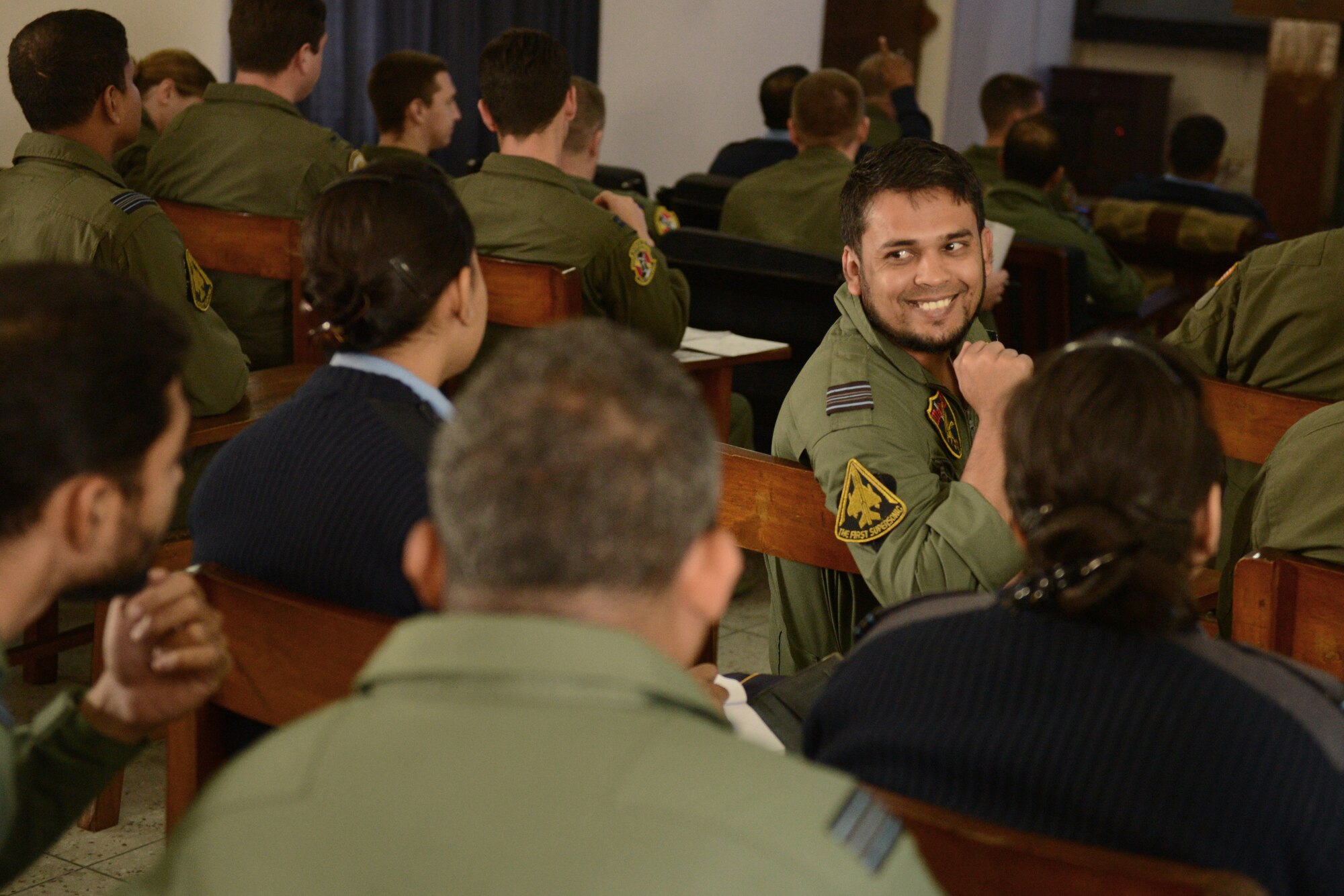 A Bangladesh Air Force F-7BG fighter pilot assigned to 5th Squadron discusses a mission with fellow pilots during Exercise COPE SOUTH at BAF Base Bangabandhu,  Bangladesh, Jan. 28, 2015. COPE SOUTH is a Pacific Air Forces-sponsored, bilateral tactical airlift exercise conducted in Bangladesh, with a focus on cooperative flight operations, day and night low-level navigation, tactical airdrop, and air-land missions as well as subject-matter expert exchanges in the fields of operations, maintenance and rigging disciplines. (U.S. Air Force photo by 1st Lt. Jake Bailey/Released)