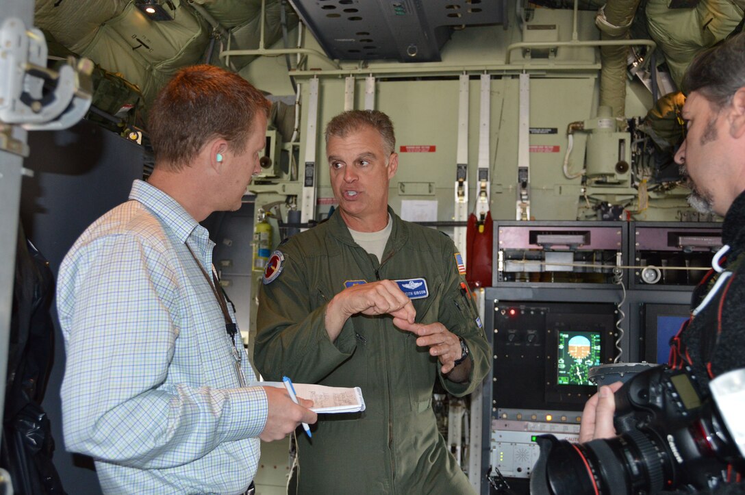 TYNDALL AIR FORCE BASE, Fla. - Lt. Col. Keith Gibson, Director of Operations, 53rd Weather Reconnaissance Squadron, explains a point about WC-130J capabilities to Chris Olwell, a reporter with the Panama City News Herald. Gibson and other aircrew members were here to participate in a two-day working group about WC-130J mission capabilities. Prior to their departure, they opened the aircraft to tours for Tyndall members and local media representatives. ( U.S. Air Force photo by Mary McHale/Released)