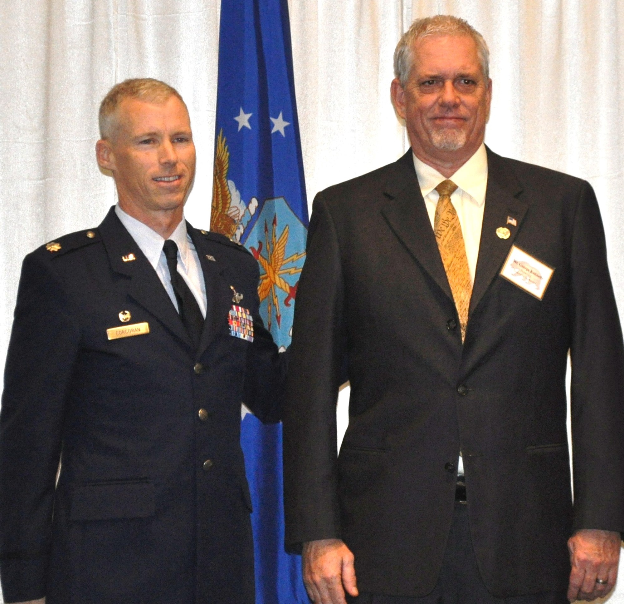 TRAVIS AIR FORCE BASE, Calif. -- Lt. Col. Thomas Corcoran, 70th Air Refueling Squadron commander, welcomes his new honorary commander, George Kennedy, at the Jan. 22 induction ceremony at Travis. Kennedy is the Director of Green Beans Coffee Company in San Rafael, Calif. (U.S. Air Force photo/Ellen Hatfield)