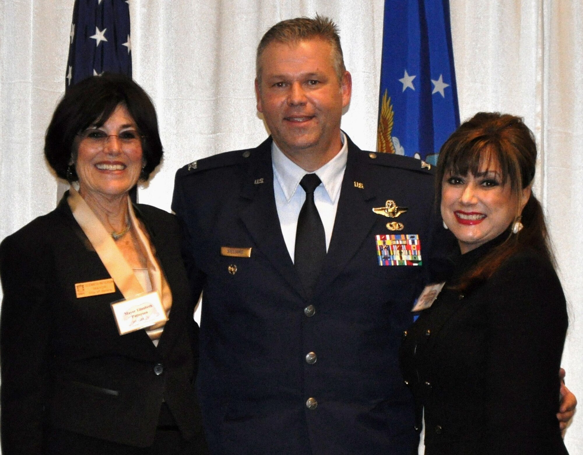 TRAVIS AIR FORCE BASE, Calif. 349th Air Mobility Wing commanders welcomed new Honorary Commanders for 2015, at an induction ceremony Jan. 22. Pictured here is 349th AMW Vice Commander, Col. Patrick Williams, flanked on the left by his outgoing honorary, the Honorable Elizabeth Patterson, and on the right by Ms. Kelly Placeres, his incoming honorary. (U.S. Air Force photo/Ellen Hatfield)