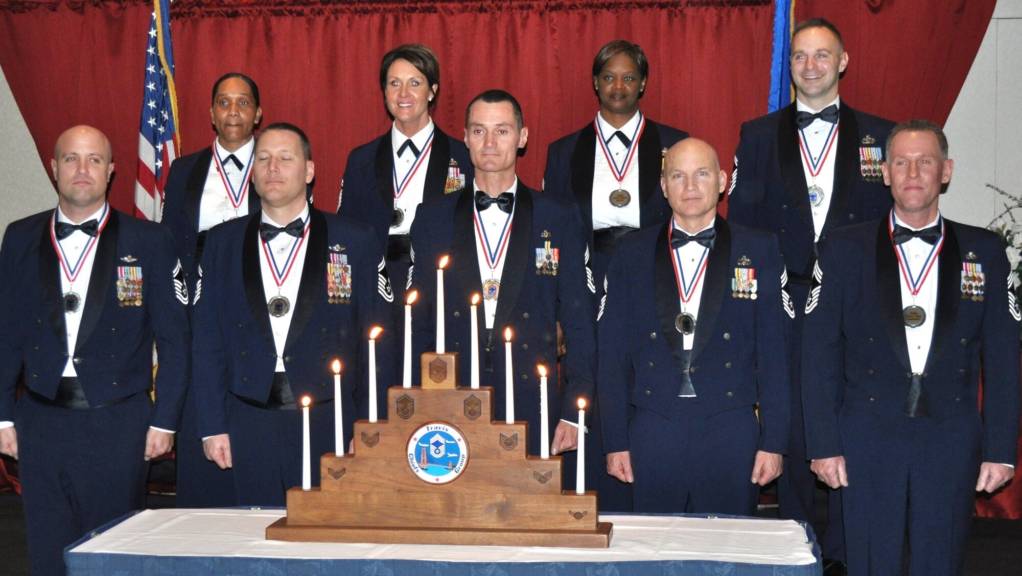 TRAVIS AIR FORCE BASE, Calif. -- Travis Air Force Base recognized nine new chief master sergeants Jan. 23, at a special ceremony and banquet. Highlights of the evening included guest speaker, Chief Master Sgt. Victoria Gamble, command chief master sergeant, Air Mobility Command, and a nine candle lighting ceremony, performed by airman basic through chief master sergeant, symbolic of their rise through the ranks to the top. Pictured here, from left to right, are the new chiefs: Randy L. Kay II, 6th Air Refueling Squadron, Matilda M.A. Mahone, 60th Medical Diagnostics and Therapeutics Squadron, Michael B. Thomas, 21st Airlift Squadron, Vanessa A. Trujillo, 60th Air Mobility Wing, Mark A. Brown, 349th Security Forces Squadron, Aretha R. Chandler, 349th Force Support Squadron, Scott A. Bryant, 55th Aerial Port Squadron, Jamie M. Auger, 571st Contingency Response Group, and Darren A. Thews, 349th Aircraft Maintenance Squadron. (U.S. Air Force photo/Ellen Hatfield)
