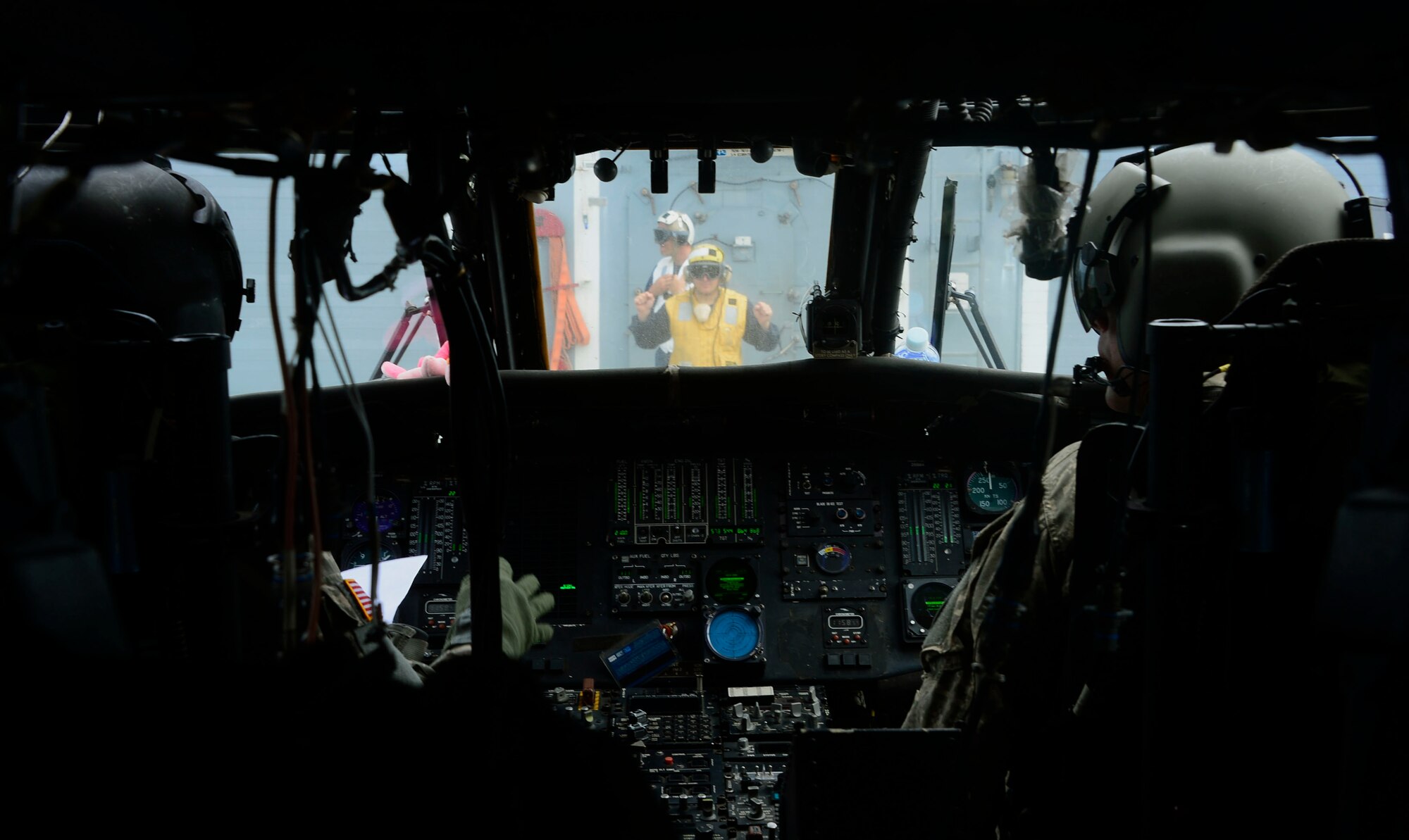 A U.S. Navy aircraft handling officer prepares members of the 1st Battalion, 228th Aviation Regiment for takeoff during deck landing qualifications off the coast of Honduras, Feb. 1, 2015.  The 1-228th Avn. Reg. aircrew participated in deck landing qualifications on board the USS Kauffman to qualify pilots and crew chiefs on shipboard operations.  Kauffman is on its final scheduled deployment to the U.S. Southern Command area of responsibility supporting multinational, counter-narcotics operation known as Operation Martillo. (U.S. Air Force photo/Tech. Sgt. Heather Redman)