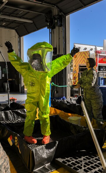 U.S. Air Force Senior Airman Bryana Payne, 23d Aerospace Medicine Squadron bioenvironmental engineering technician, scrubs down Airman 1st Class Brandon Unpingco, 23d Civil Engineer Squadron firefighter, during a hazardous material training Jan. 28, 2015, at Moody Air Force Base, Ga. Unpingco went through several stations of a simulated decontamination line to remove his personal protection equipment without spreading hazardous materials. (U.S. Air Force photo by Senior Airman Sandra Marrero/Released)
